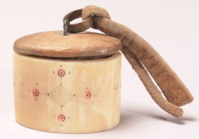 Quid box used to hold Iqmik, from the Anchorage Museum of History and Art, Goodnews Bay, early 20th century.  Walrus ivory, wood, ocher, rawhide, brass